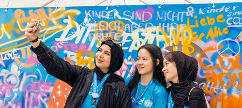A group of girls take a selfie.