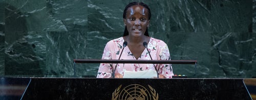 Young person standing behind lectern. 