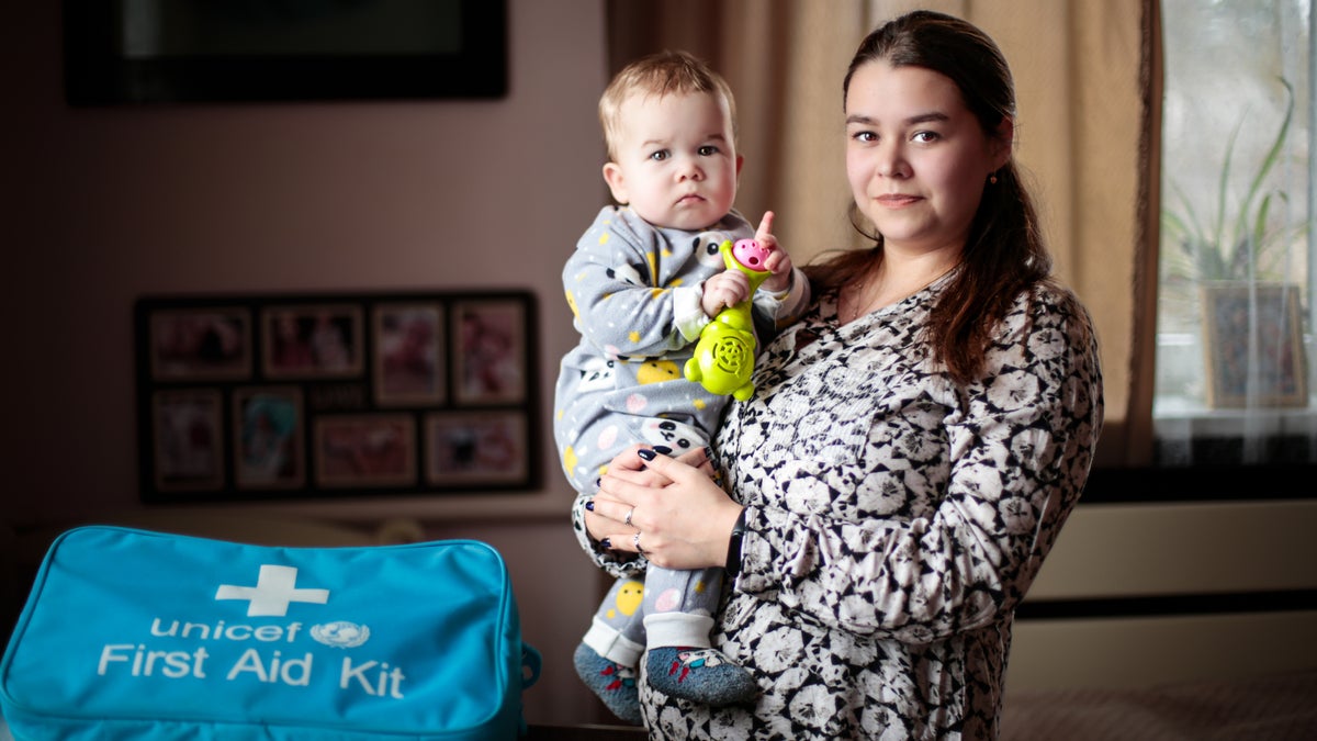 A mother posing with her baby boy in Ukraine.