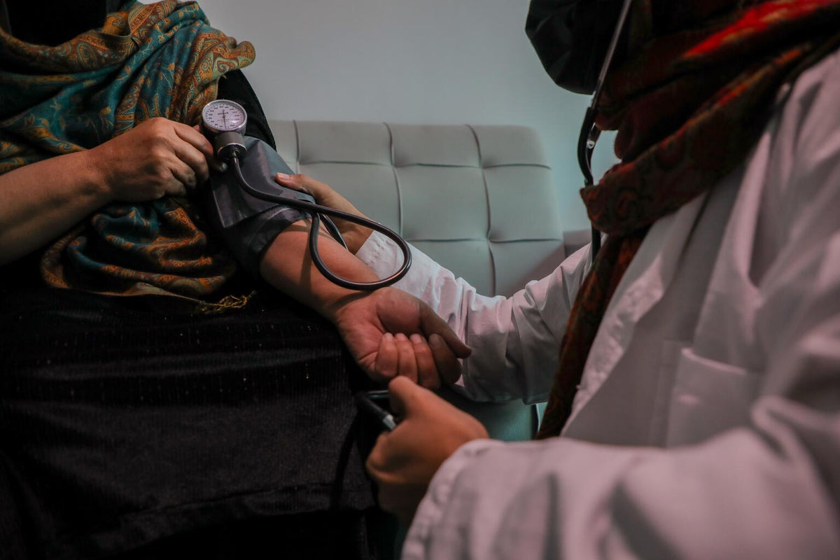 Fatima, 17, monitors her mum's blood pressure. 