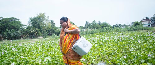 Health worker walks in a field