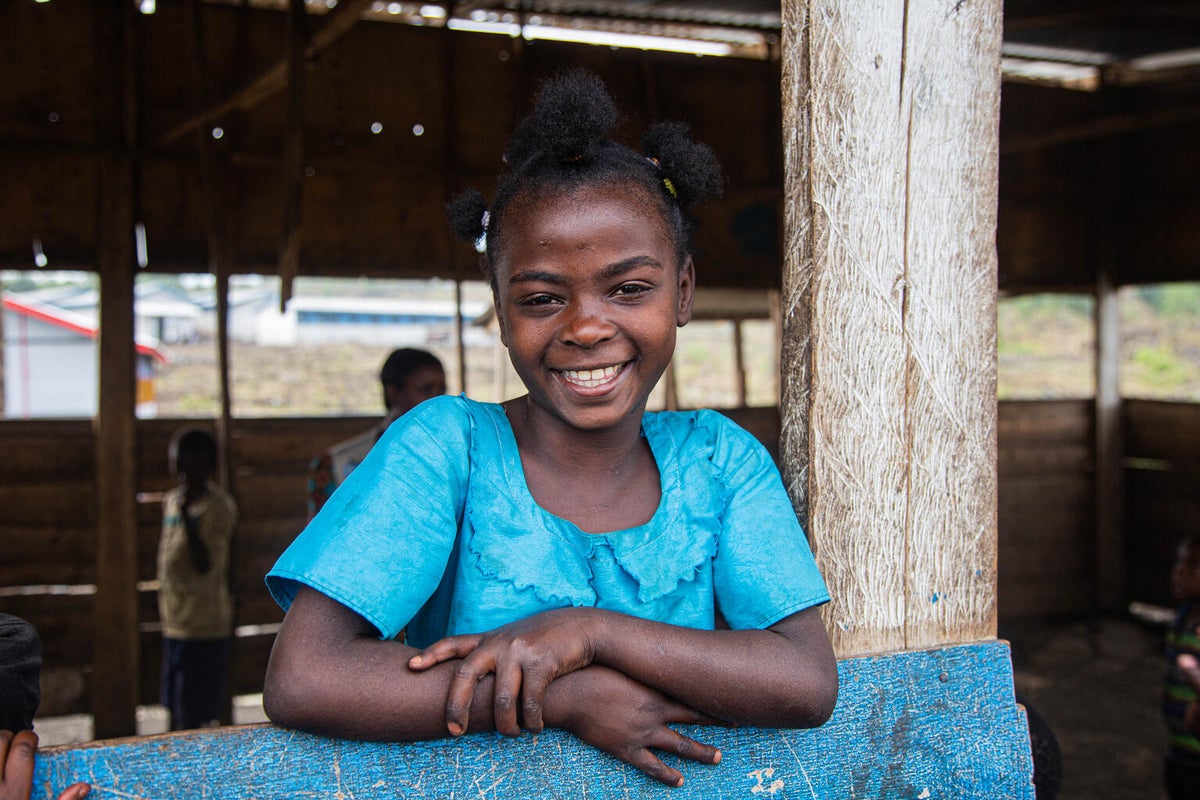 A young girl smiling. 