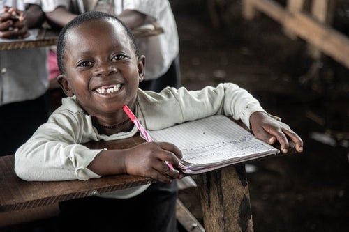 A boy sitting in a classroom.