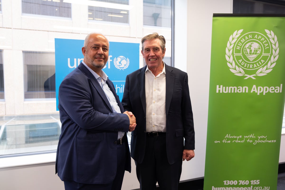 UNICEF Australia CEO Tony Stuart and Human Appeal Australia Director Bashar Al‑Jamal shake hands. 