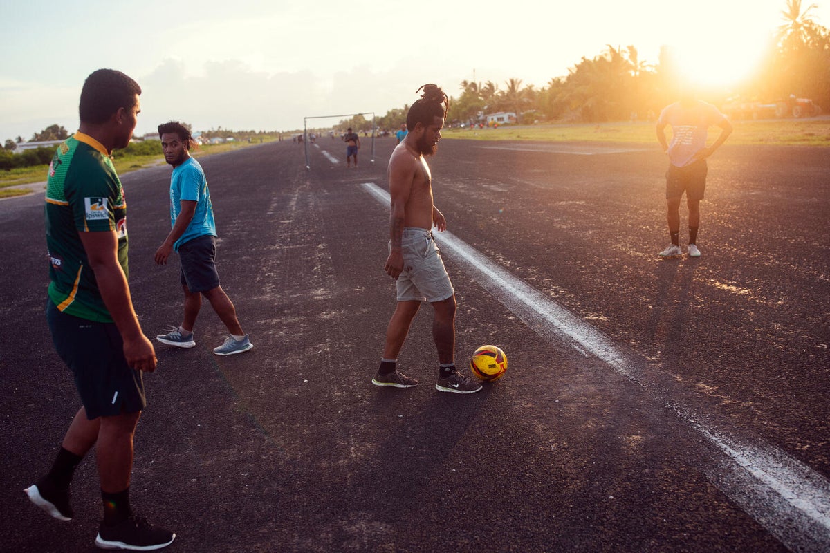 Making the most of rare available land, Tuvaluans often gather on the runway of the country’s only international airport to play football and other sports.