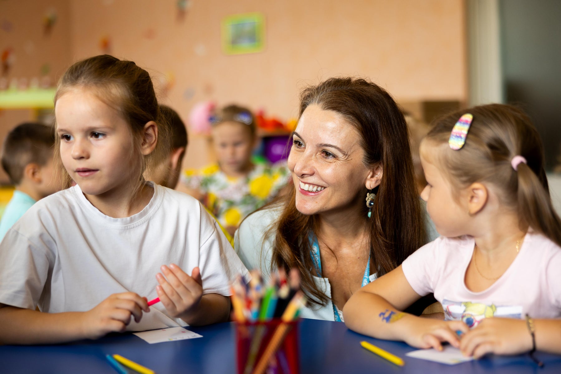 Teacher with students at a table in class