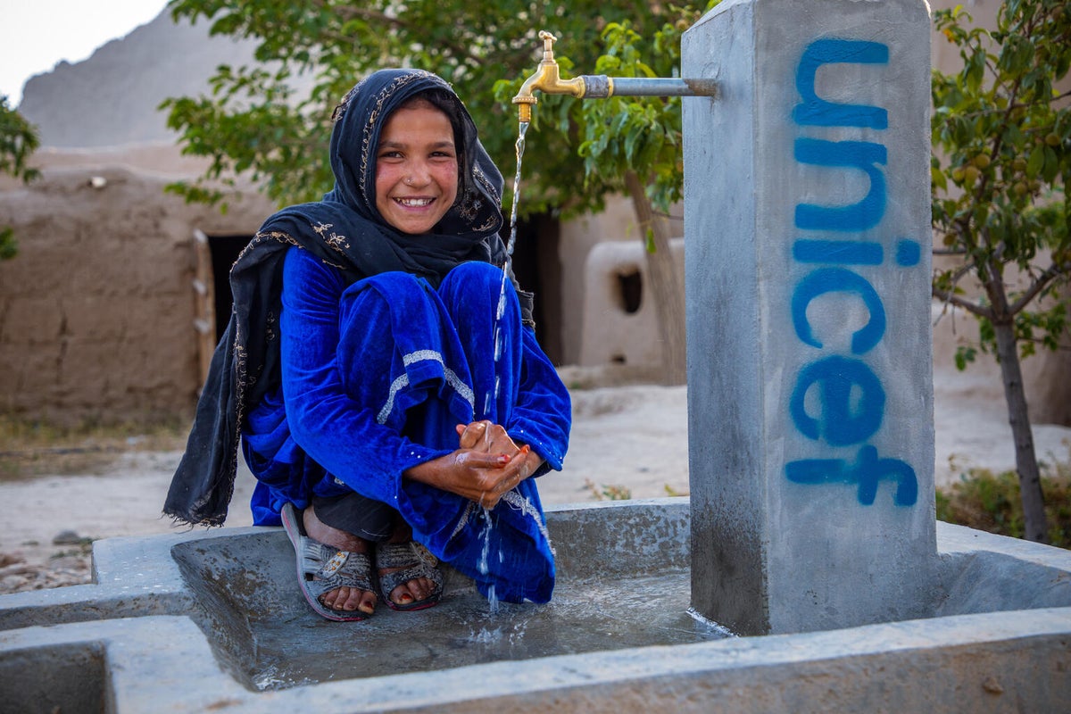 A young girl in Afghanistan accessing clean water