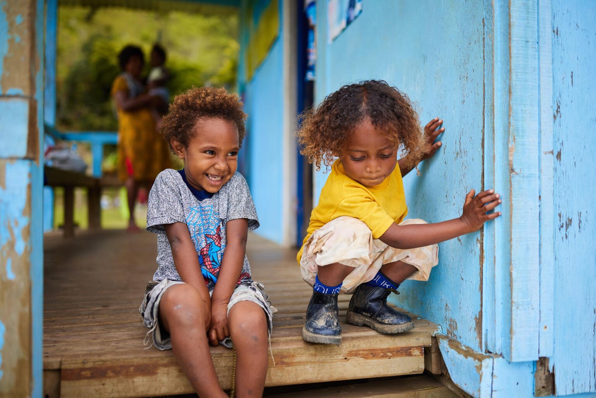In a remote mountain village in Papua New Guinea, two young boys play outside a UNICEF-supported health centre. 