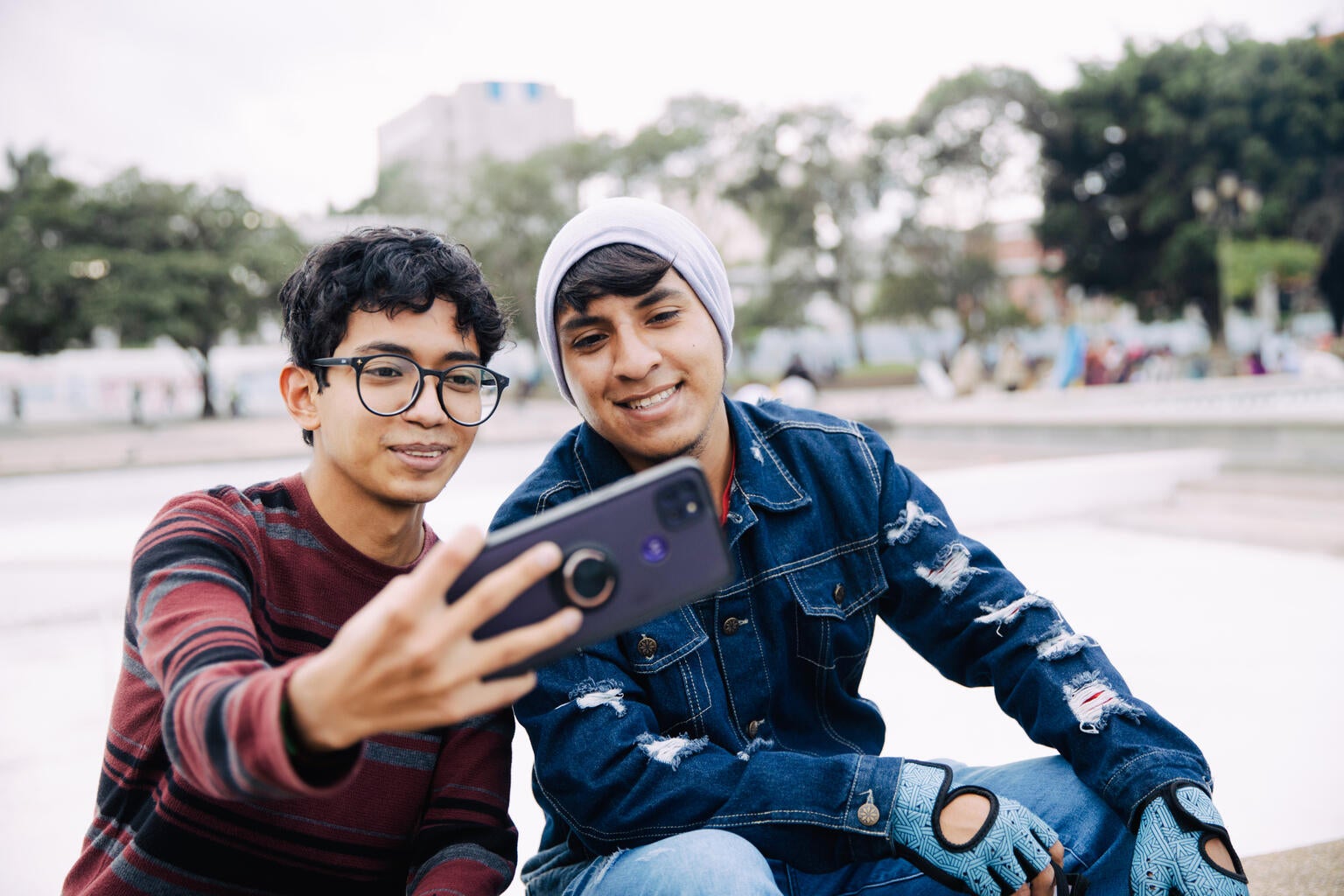Two young boys take a selfie together.