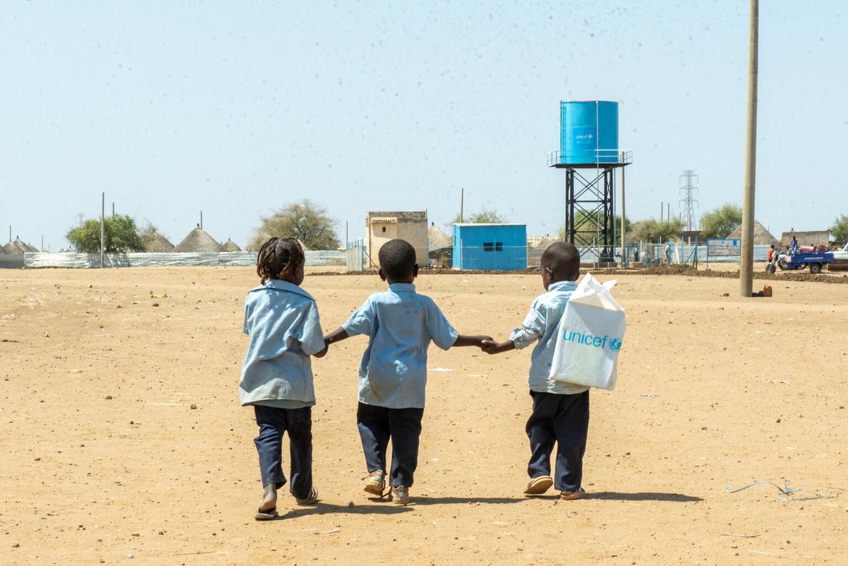 Children walk home from a UNICEF-supported child-friendly space at a IDP camp.