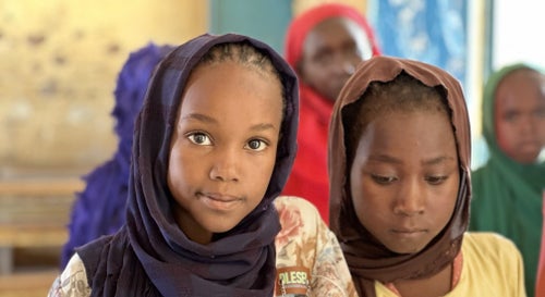 Two girls from Sudan looking at the camera