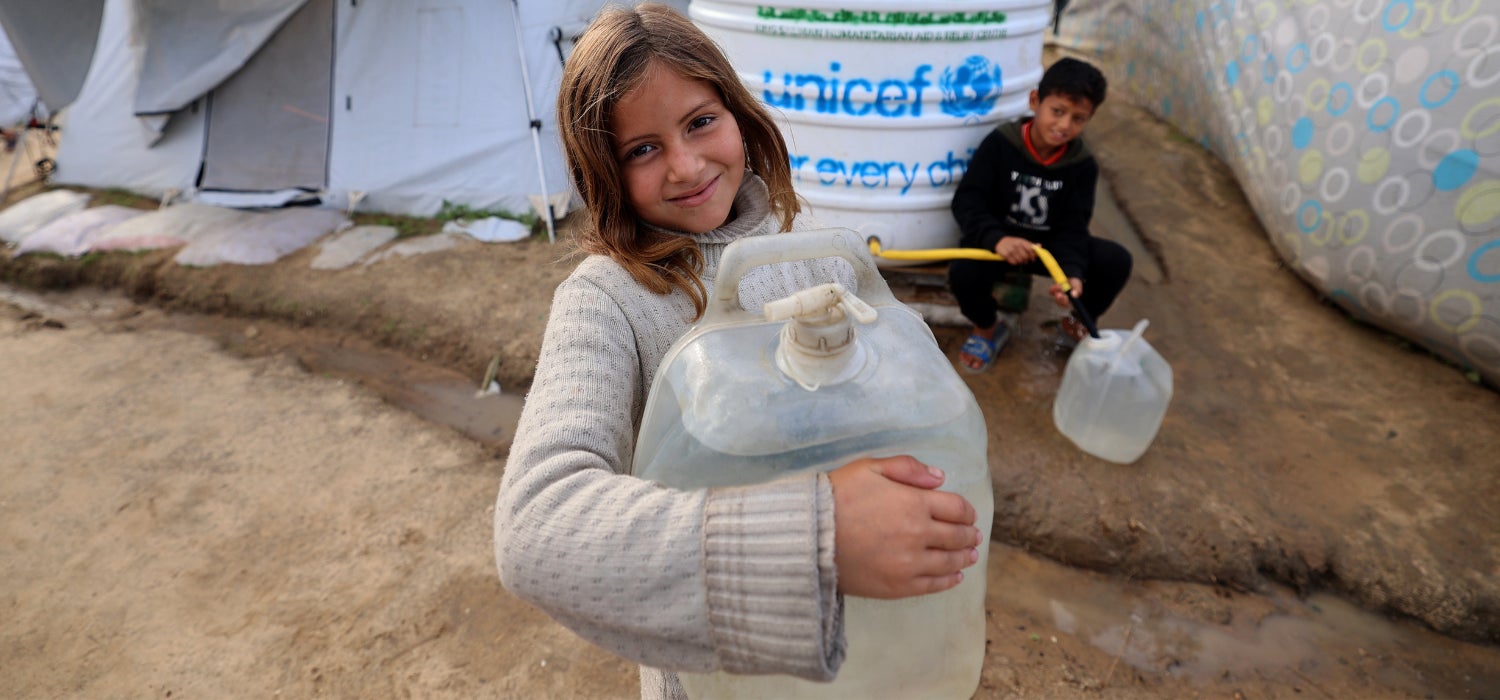 A girl collecting water. 