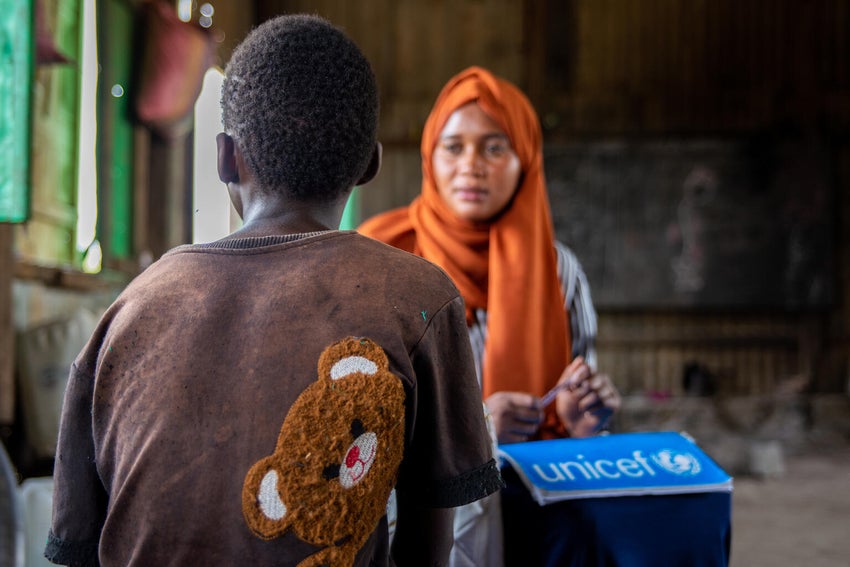 A teenage boy finds solace at a UNICEF-supported centre while waiting to be reunited with his family, who were separated during violence in Sudan. 