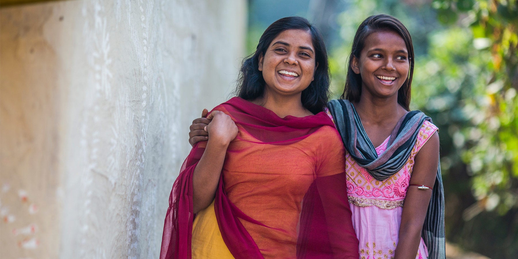 17 years old Mamta and 16 years old Vinita stand outside their home in the village of Berhabad, in Jamua block of Giridih