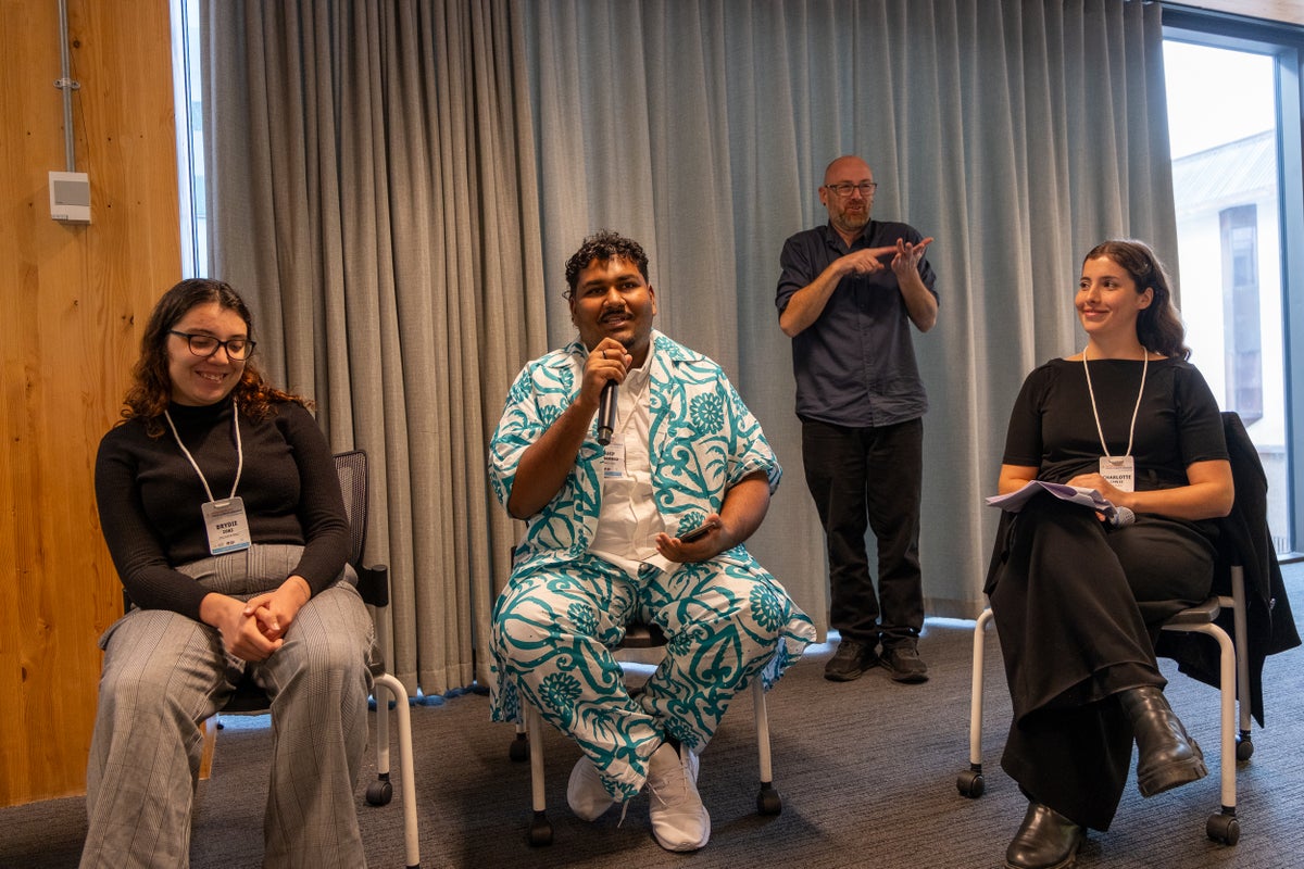 A young Pasifika man speaks during a panel discussion at the 2025 Dialogue. 
