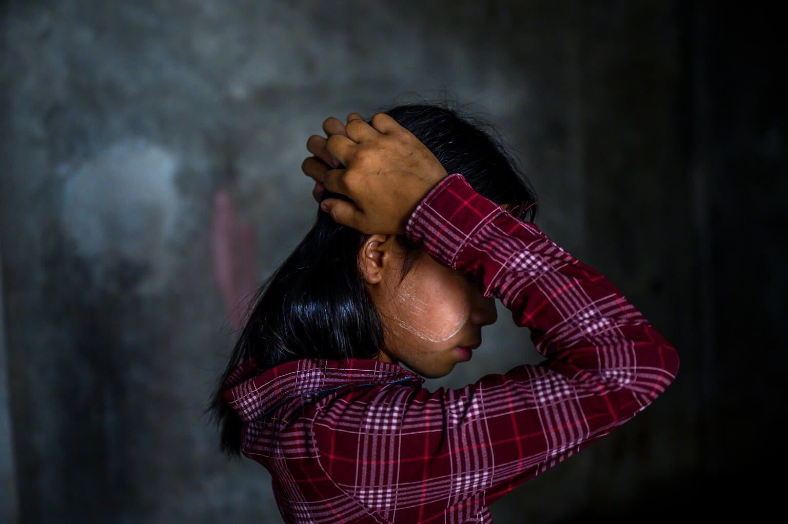 A young girl in Myanmar who has been impacted by the ongoing conflict and humanitarian situation. 