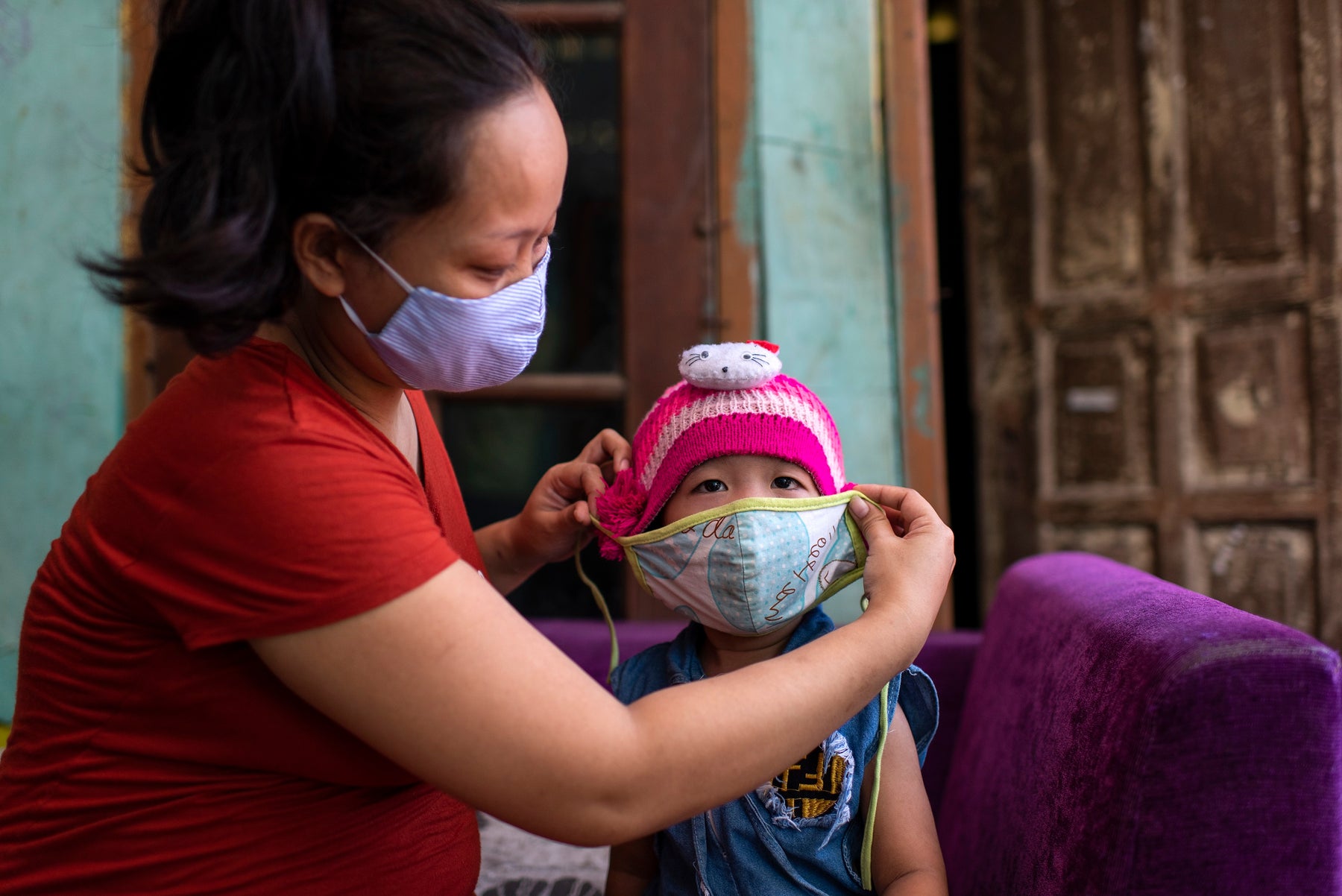 Mother puts on child mask