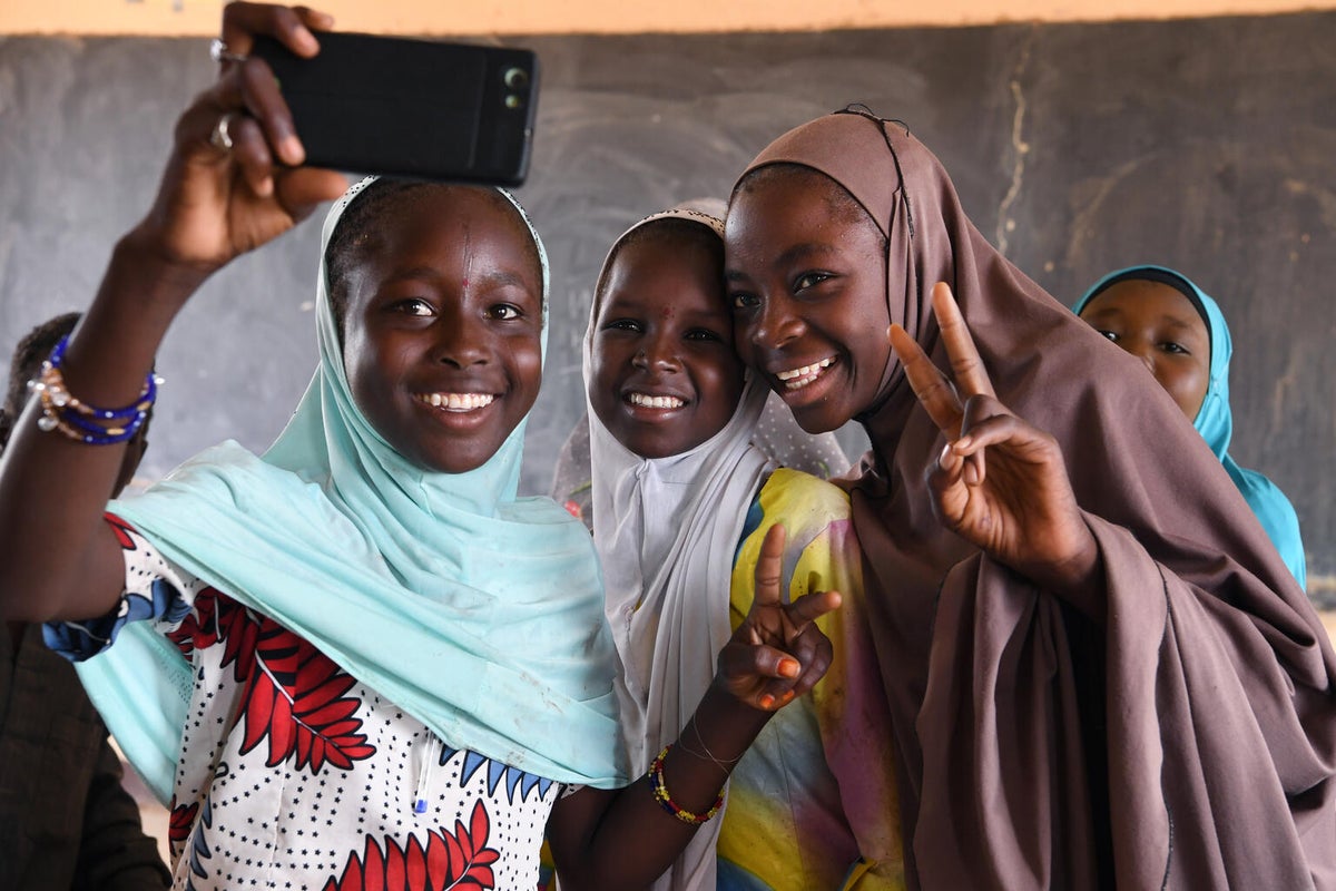 A group of girls take a selfie in a classroom in Niger.