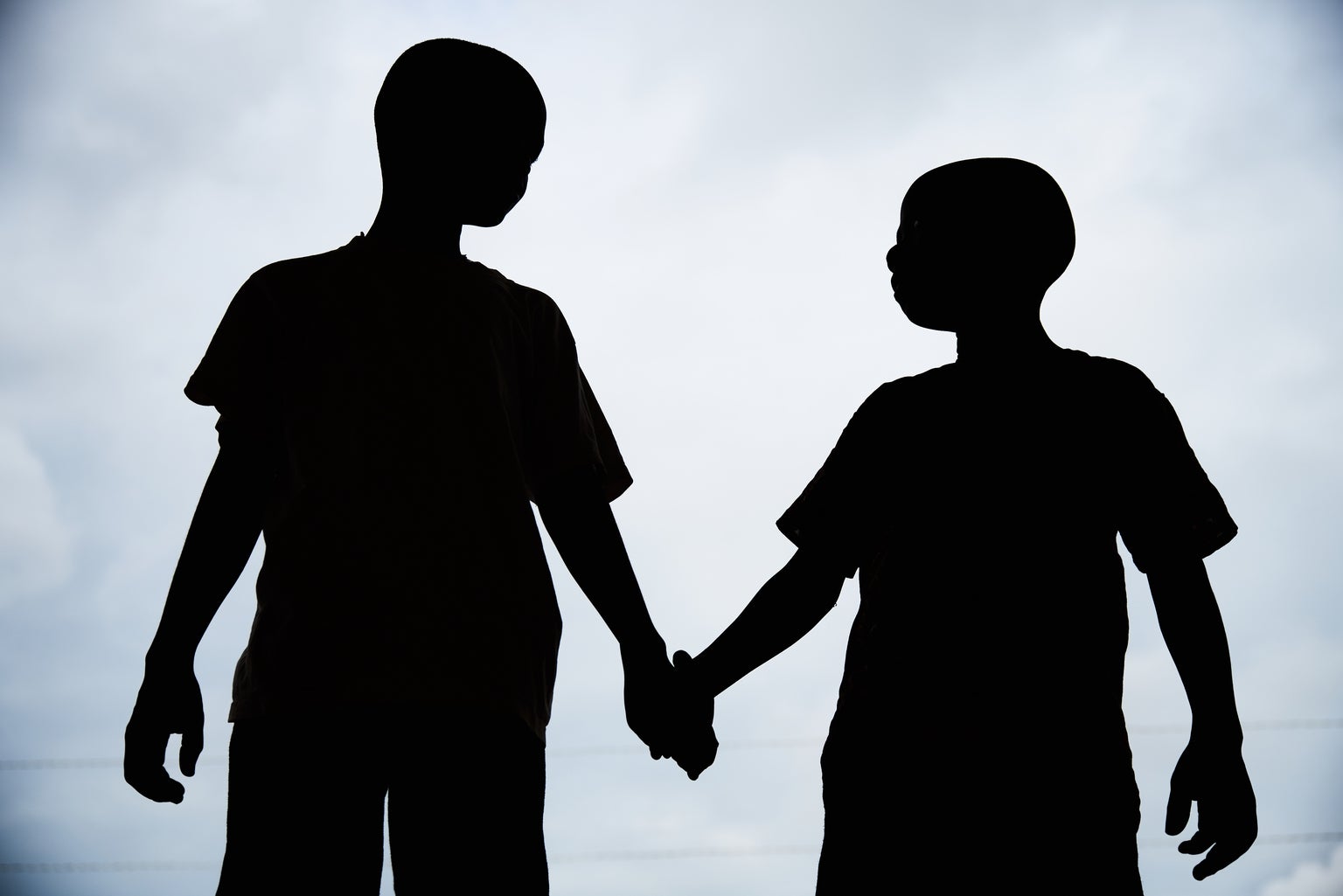 Boys hold hands at the HAPPY KIDS and Adolescent NGO in Kenema, Kenema District, Sierra Leone, Sunday 4 June 2017