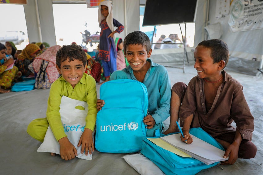 A group of boys participate in a class at a UNICEF-supported temporary learning centre for children affected by devasting floods in Pakistan.