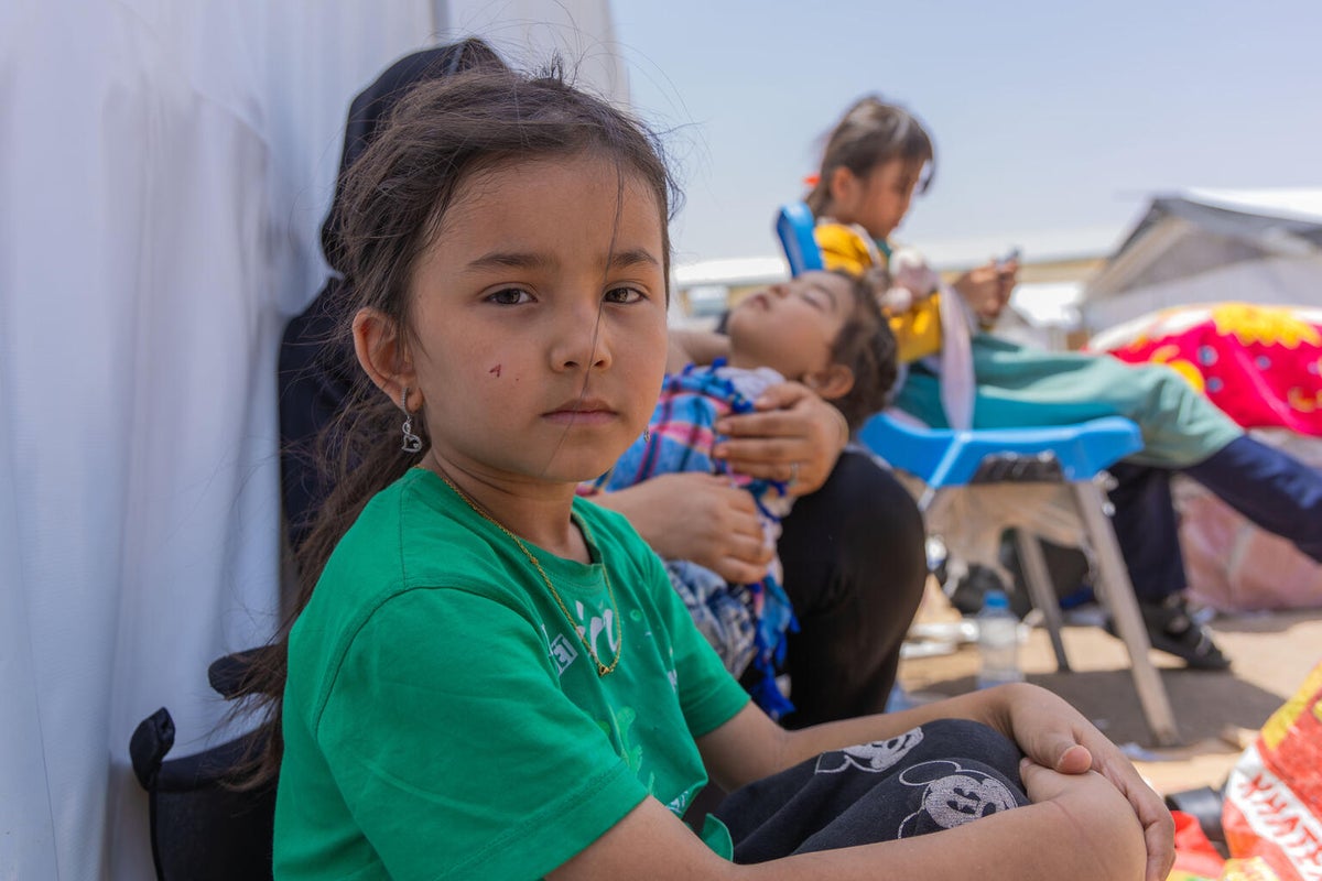 Young girl at the border between Iran and Afghanistan with her family. 