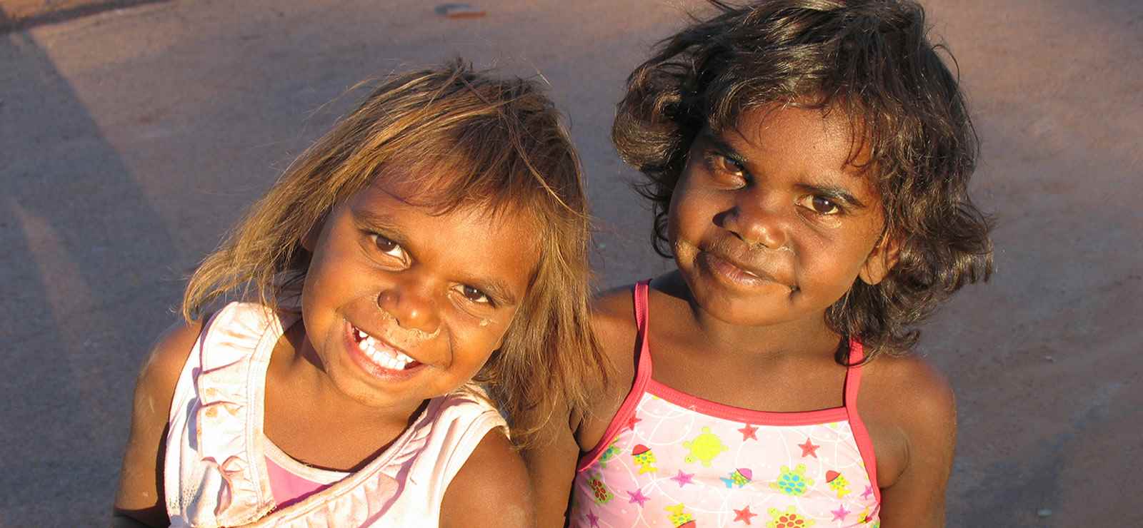 Two first nation's children smiling for camera