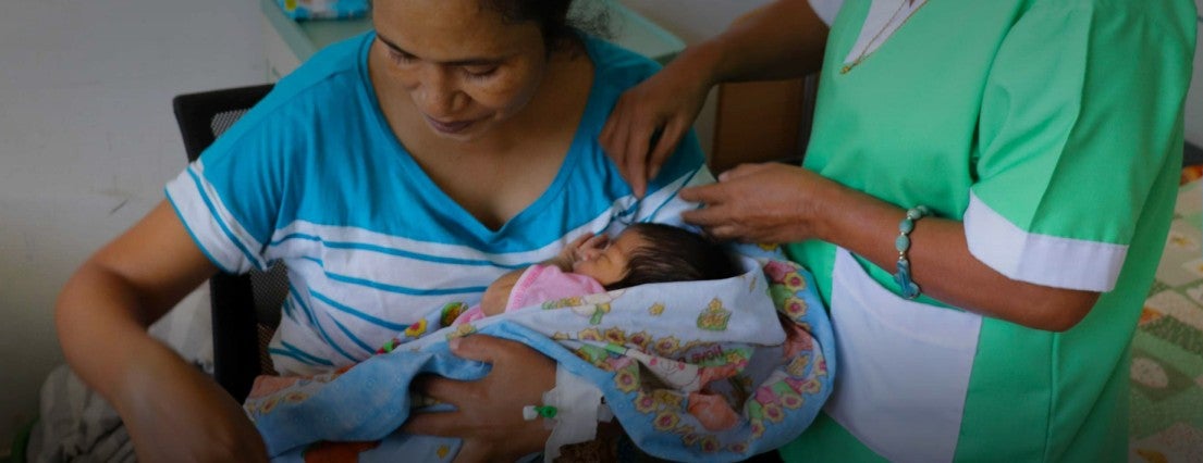 Mother holds a child