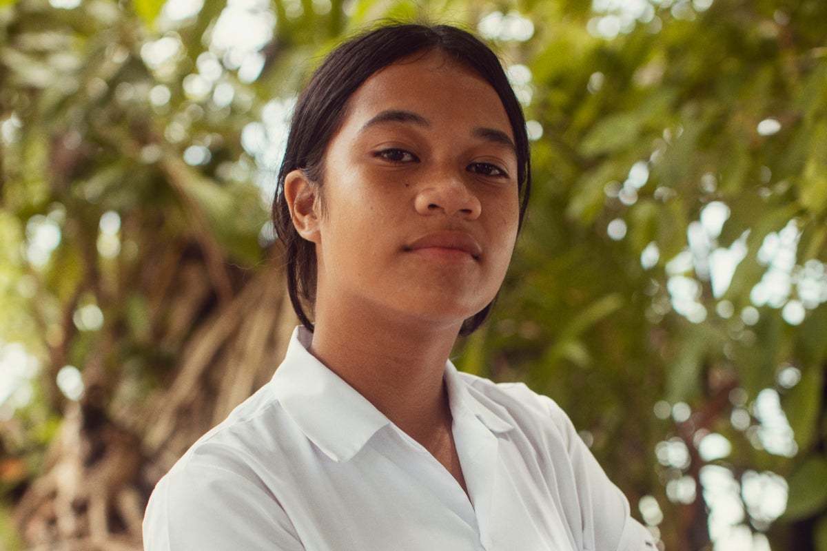 High school student Alaina, 14, poses for a photo in Tuvalu.