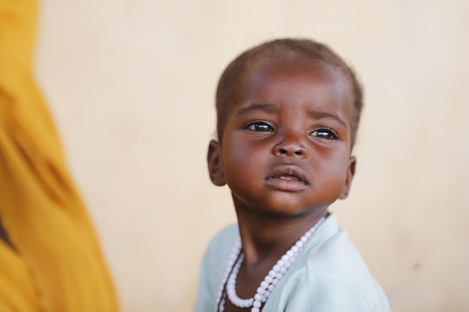 A young child in Sudan being screened for malnutrition