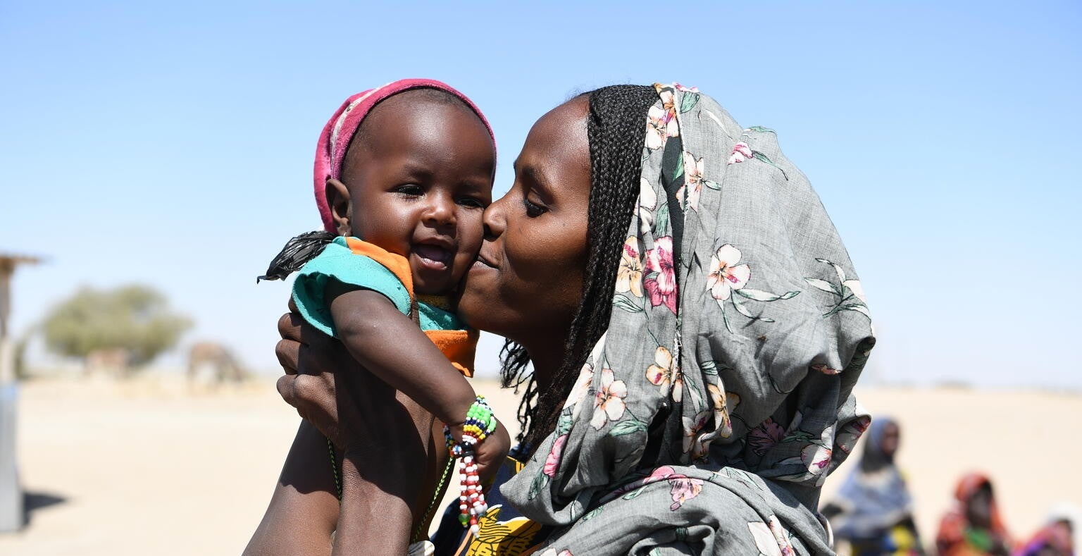 A mother holds her baby 