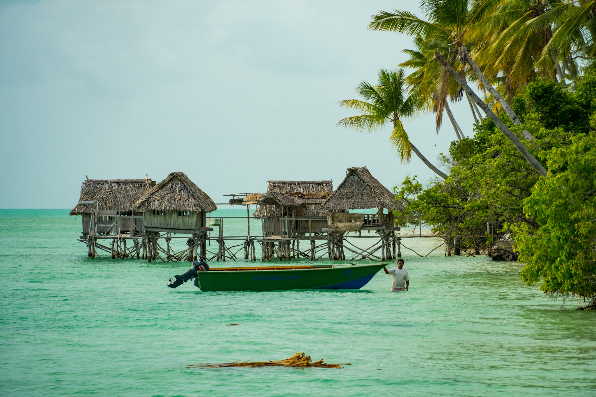 Landscape of ocean and boat in North Tarawa, Kiribati.