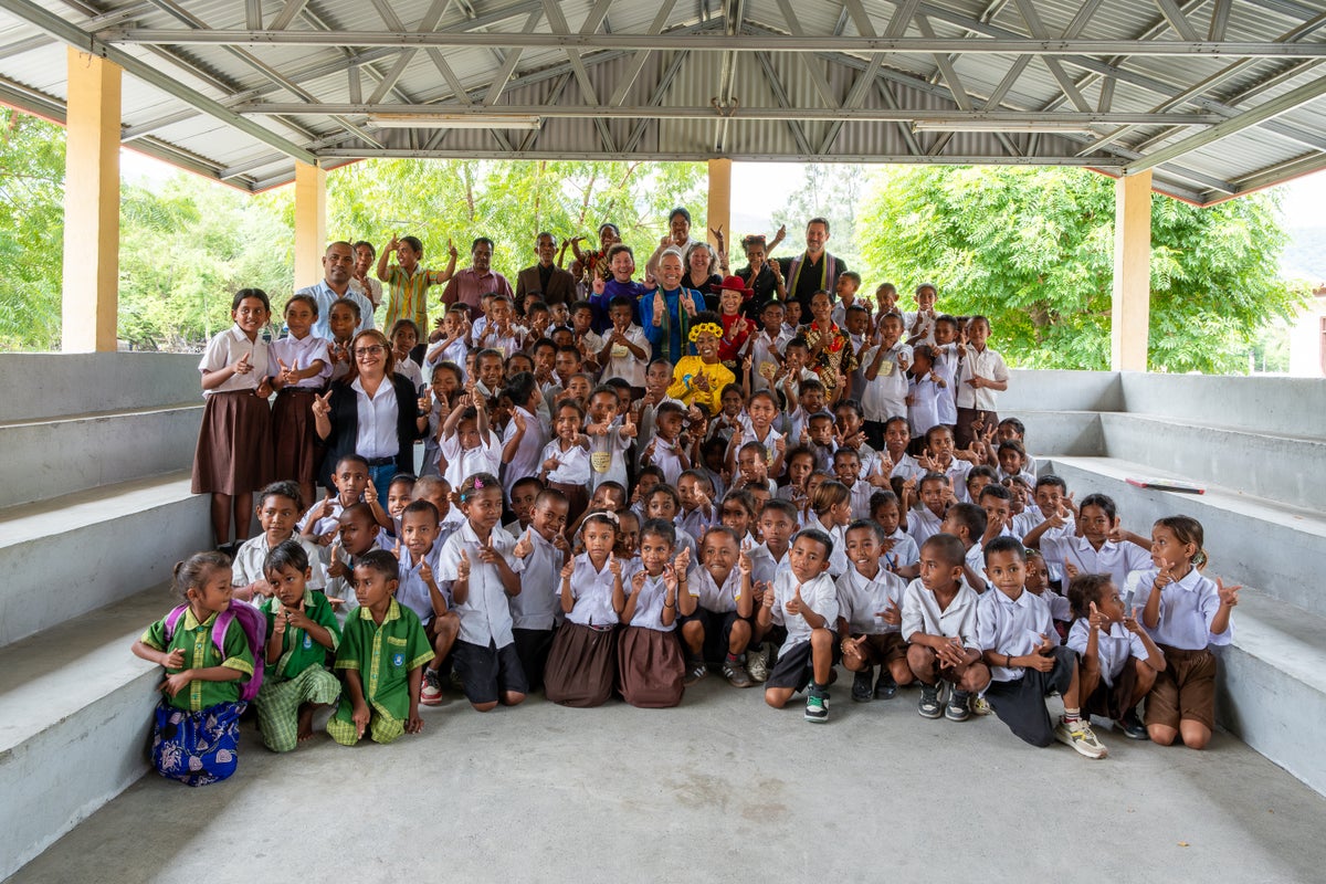 A group photo of students and a musical group.