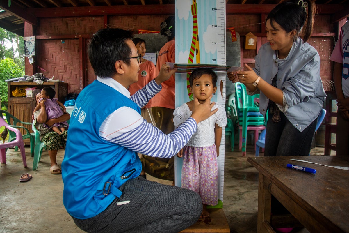 Two-year-old Ja Nu Brim undergoes nutrition screening, including weight and height measurements, during a nutrition awareness session organised by UNICEF Myanmar.