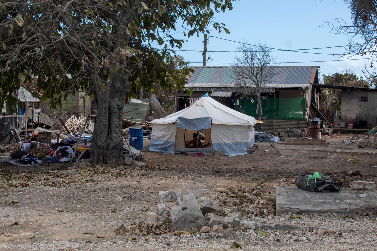 An emergency tent in front of a house.