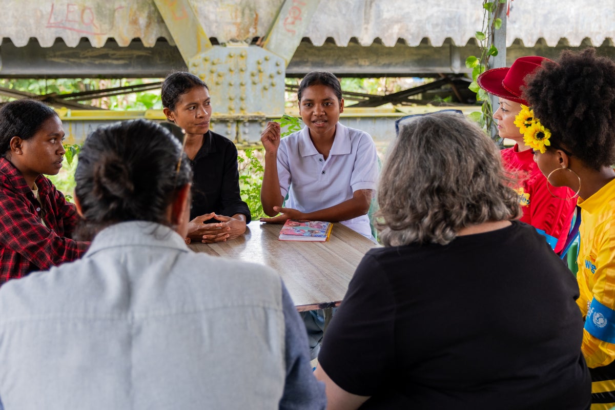 A group of young women speaking with The Wiggles and UNICEF staff.