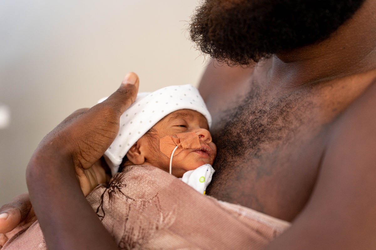 In Vanuatu, Tony holds his premature newborn using kangaroo care. 