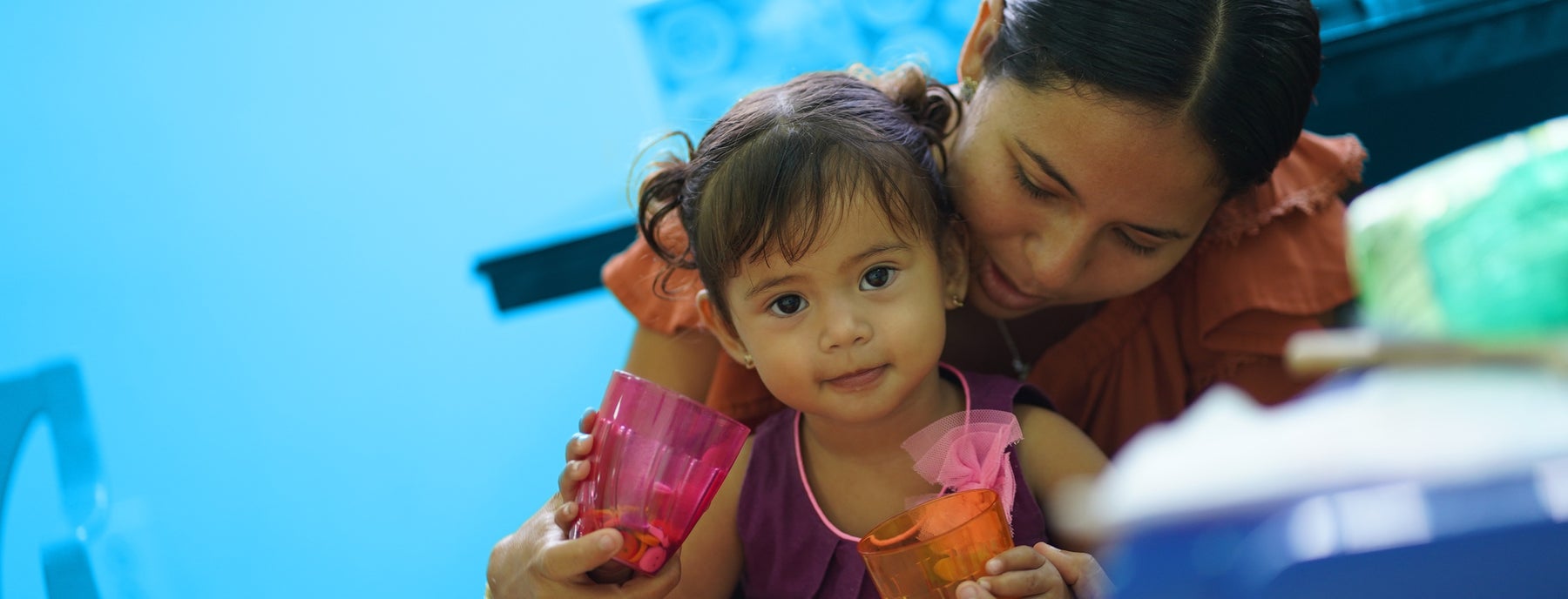 Mother and child sitting in crowd