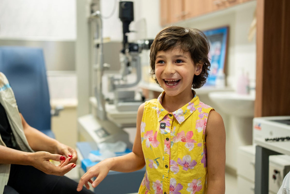Big smiles from a young girl as she receives medical care at a hospital in Lebanon.