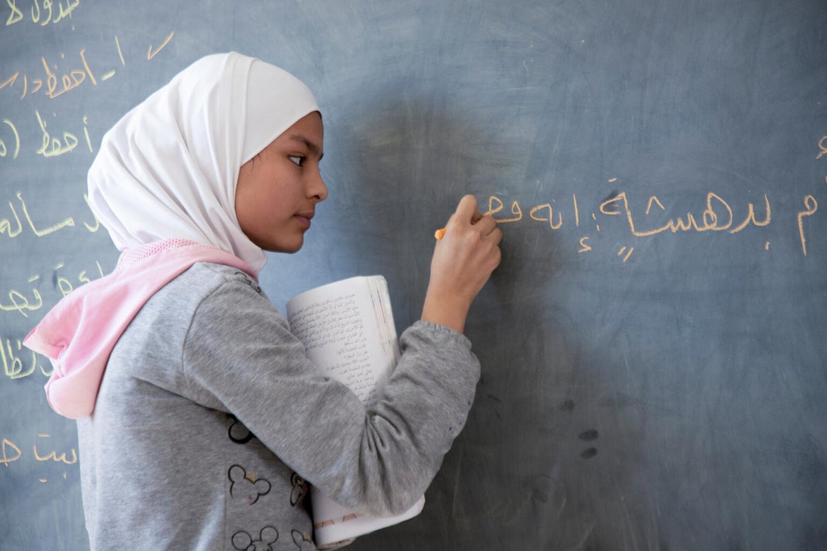 A girl writing on a chalkboard