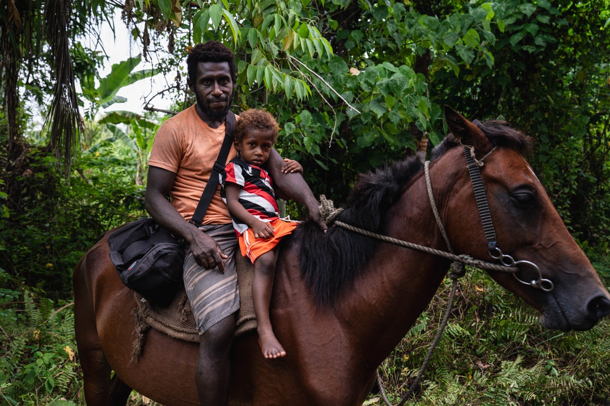 A man and his son on a horse. 