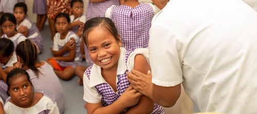 A young girl receiving the HPV vaccine in Kiribati.