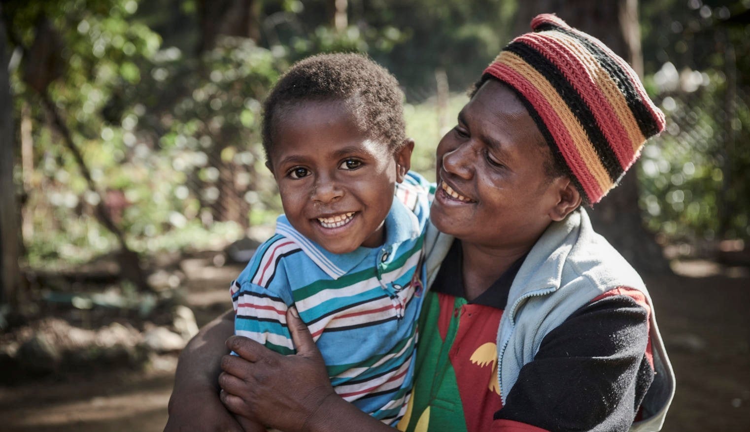 A mother and child from Papua New Guineas smiling at the camera