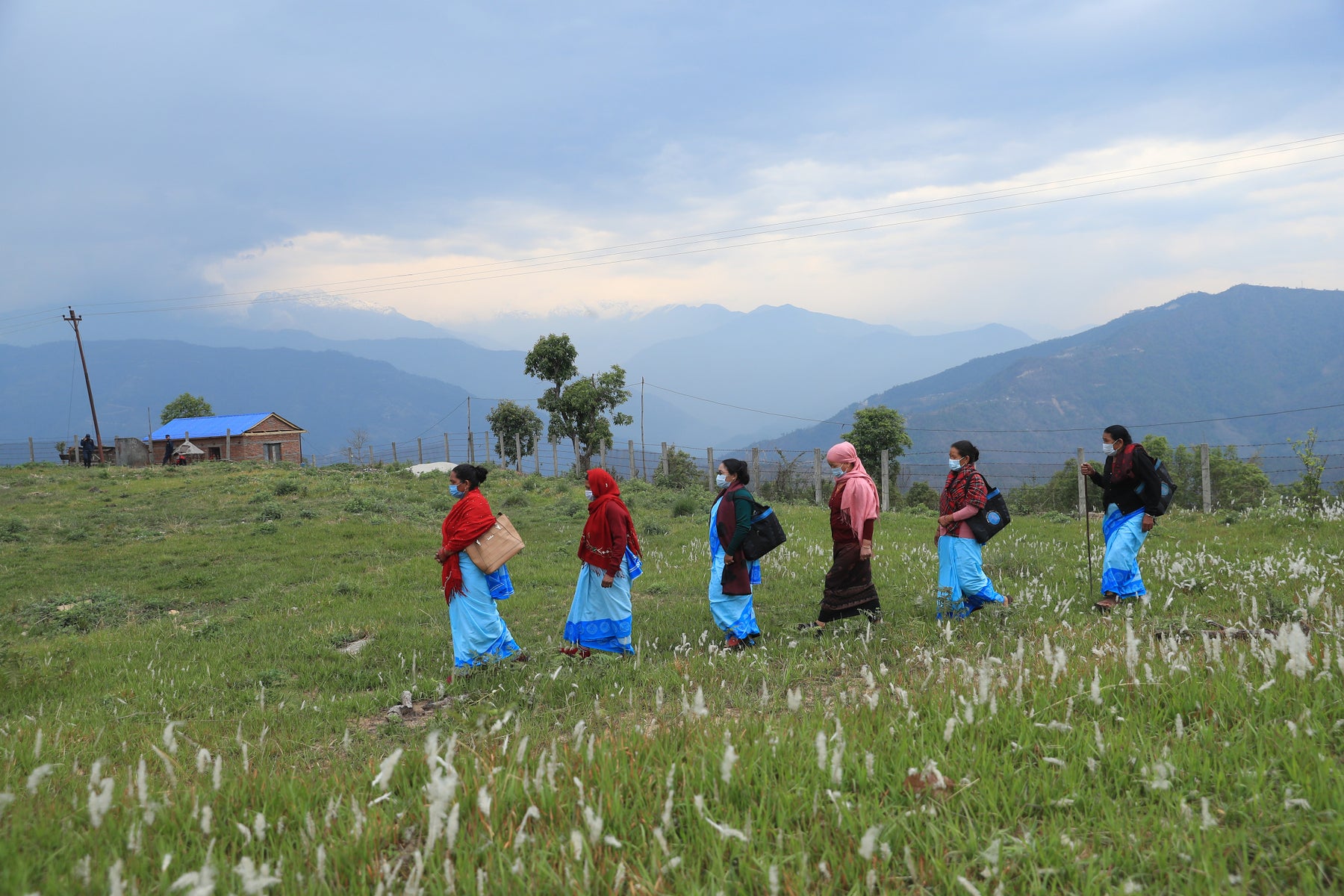 Medical workers walking across a field.