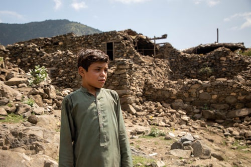 A young boy stands among the ruins of a village after the August earthquake in Afghanistan.