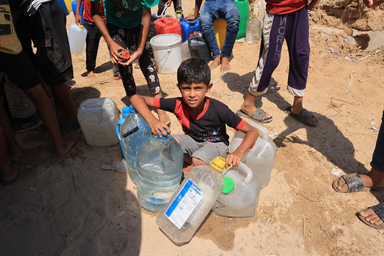 A young boy collecting water for his family in Gaza.