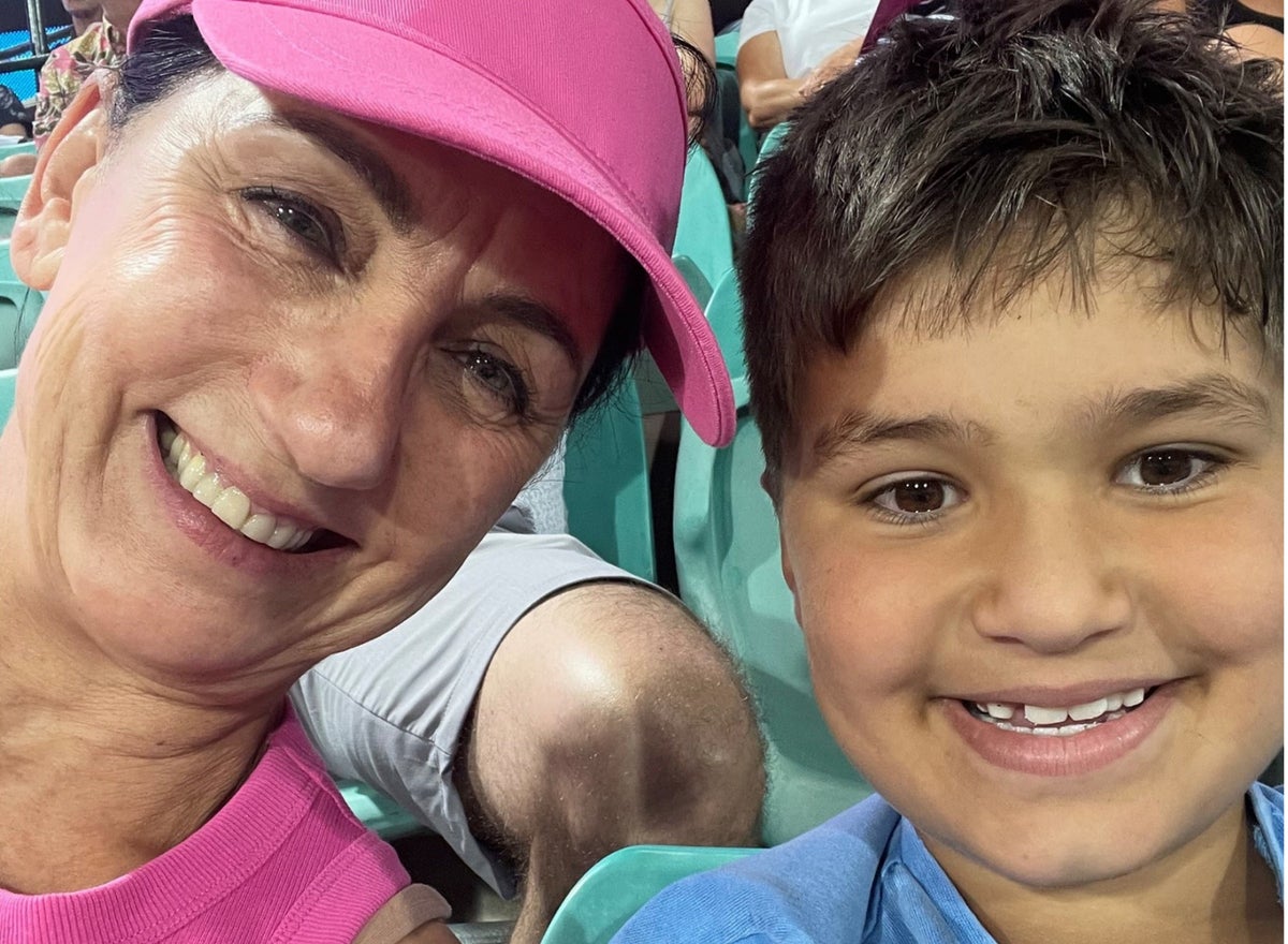 A selfie of an older woman with her young grandson.