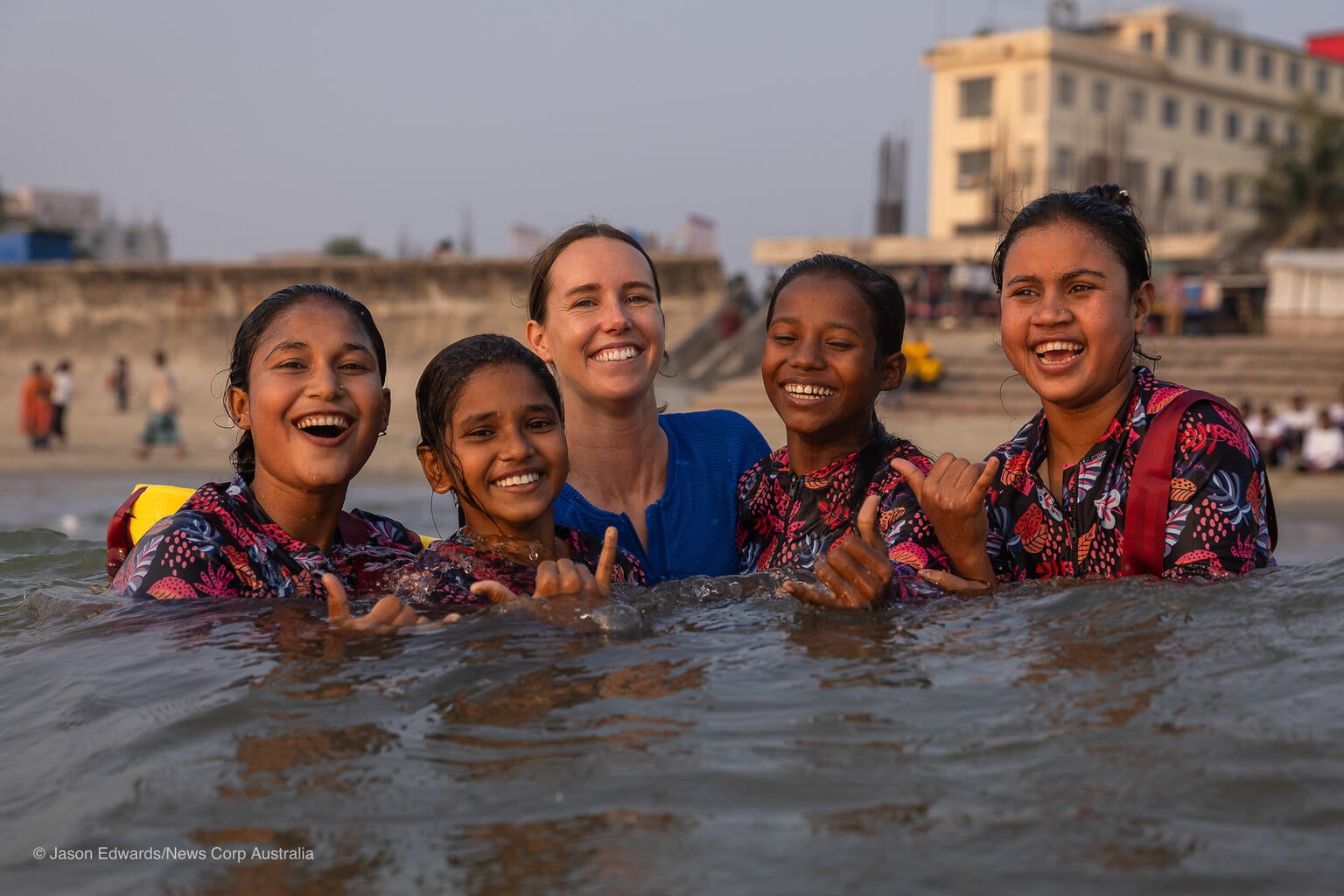 Australia's most decorated Olympian and UNICEF Australia Ambassador Emma McKeon join a young girl in Surf Camp in Cox's Bazar, Bangladesh.