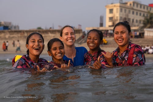 Australia's most decorated Olympian and UNICEF Australia Ambassador Emma McKeon join a young girl in Surf Camp in Cox's Bazar, Bangladesh.