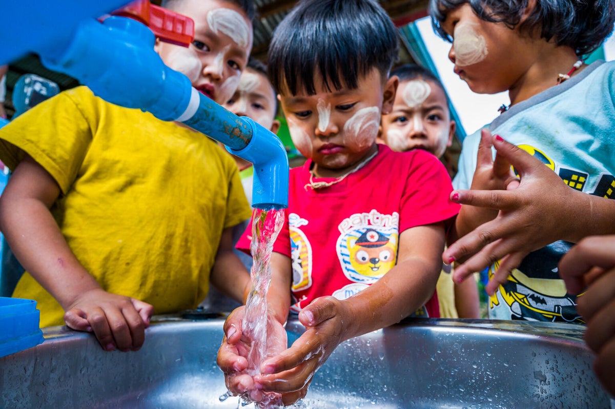 Children use newly installed handwashing stations after the earthquake destroyed school sanitation facilities, forcing them to rely on distant creeks during the hot season. 