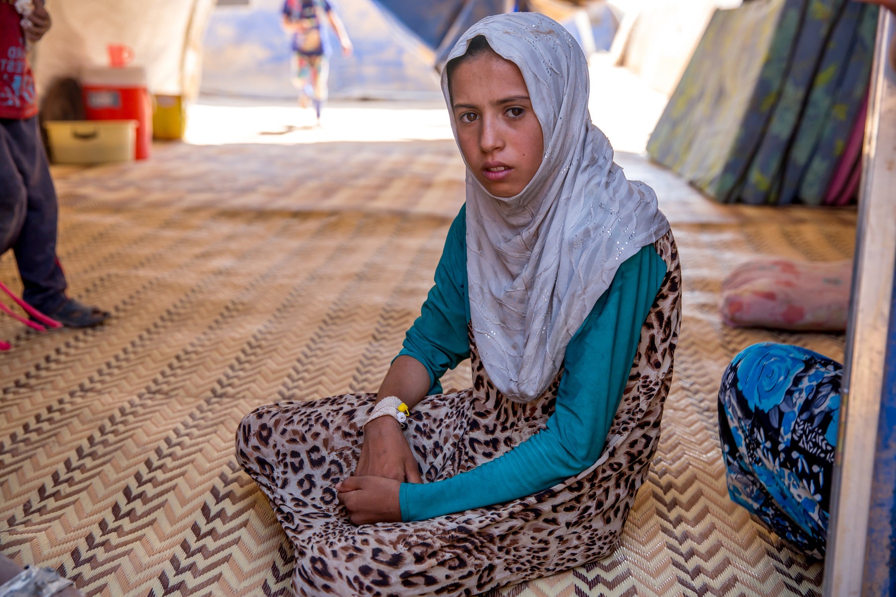 Young girls sits in a tent